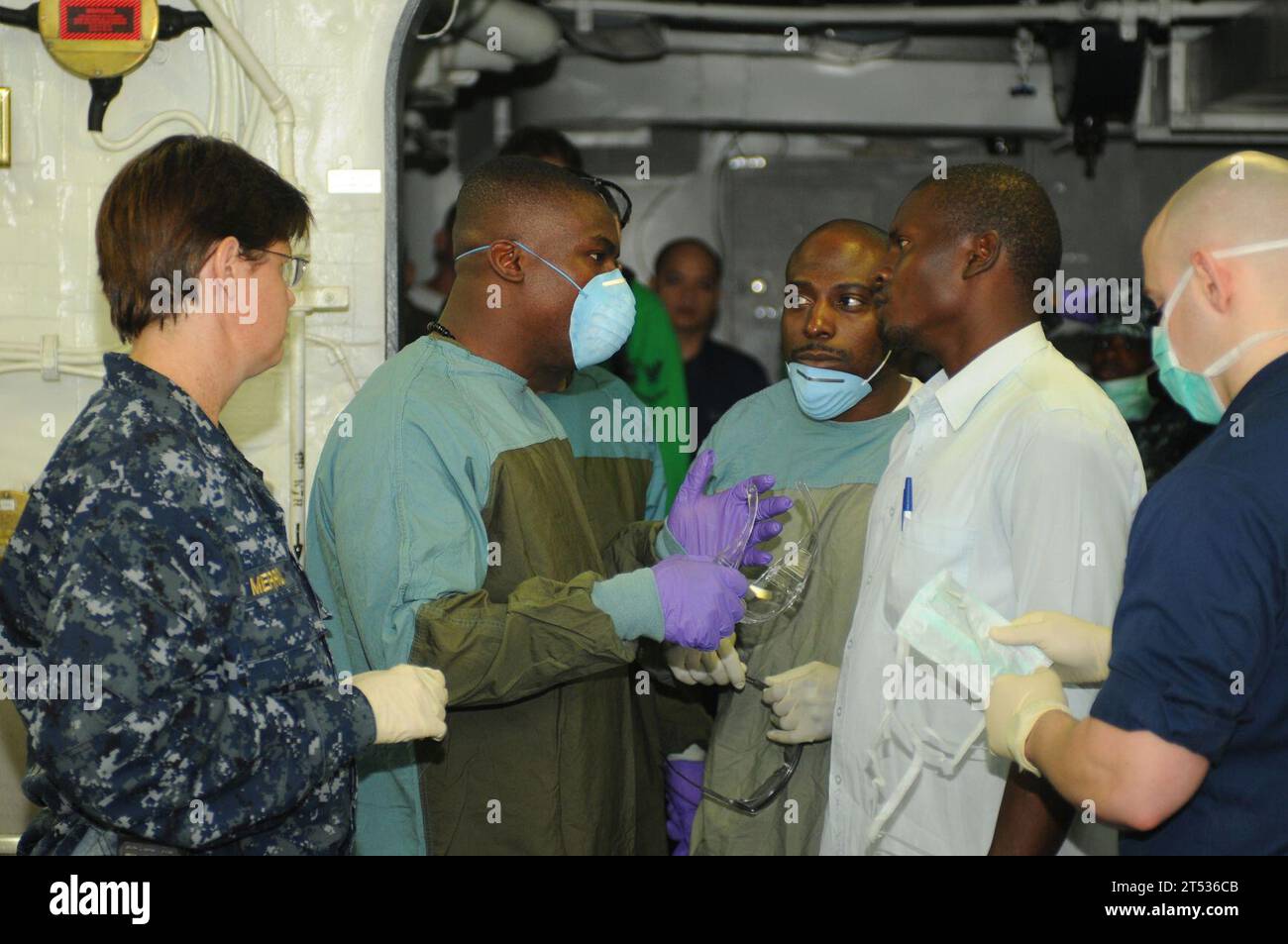 1001191831S-062 PORT-AU-PRINCE, Haiti (Jan. 19, 2010) A Haitian man speaks with the medical staff aboard the multi-purpose amphibious assault ship USS Bataan (LHD 5) about his mother's condition. His 70-year-old mother was freed from a collapsed building Jan. 19, after being trapped under rubble for seven days. Bataan is supporting Operation Unified Response, a joint operation providing humanitarian assistance following a 7.0 magnitude earthquake that struck Haiti Jan. 12, 2010. Stock Photo