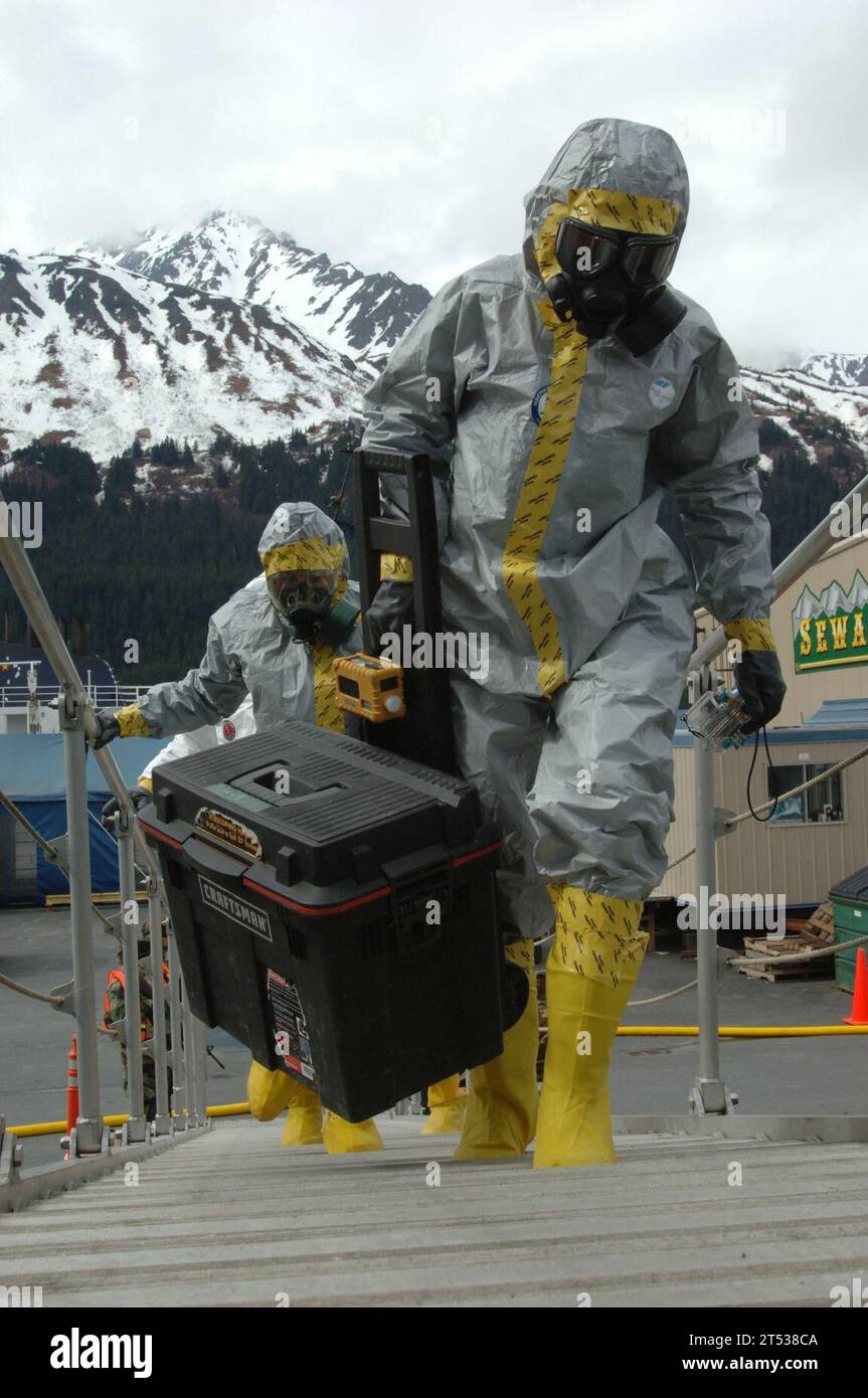 0705117949W-048 SEWARD, Alaska (May 11, 2007) Р Members of the National Guard's civil support team board Military Sealift Command (MSC) fleet replenishment oilder USNS Henry J. Kaiser (T-AO 187) in biohazard suits to investigate a simulated report of suspicious chemicals. The boarding was part of an exercise scenario for Alaska Shield/Northern Edge 2007. The civil support team worked in conjunction with the Seward police and fire departments, the Coast Guard, the FBI, and many other organizations to practice interagency coordination in an emergency situation. U.S. Navy Stock Photo