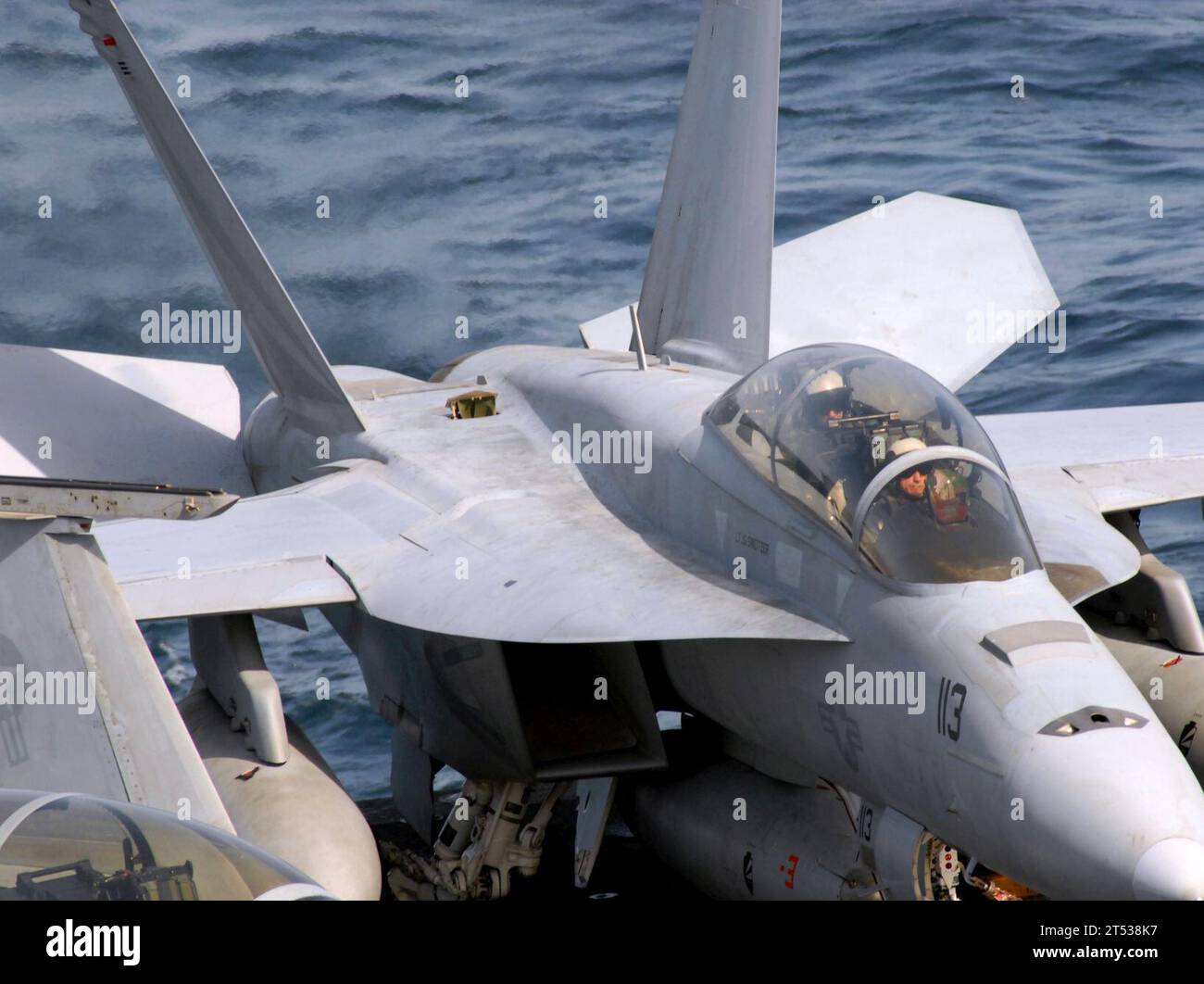 0703133038W-238 ARABIAN SEA (March 13, 2007) - Pilots assigned to the 'Black Knights' of Strike Fighter Squadron (VFA) 154 test their F/A-18F Super Hornet's ailerons prior to launch aboard Nimitz-class aircraft carrier USS John C. Stennis (CVN 74). Stennis Carrier Strike Group is on a scheduled deployment in support of Maritime Security Operations (MSO). U.S. Navy Stock Photo