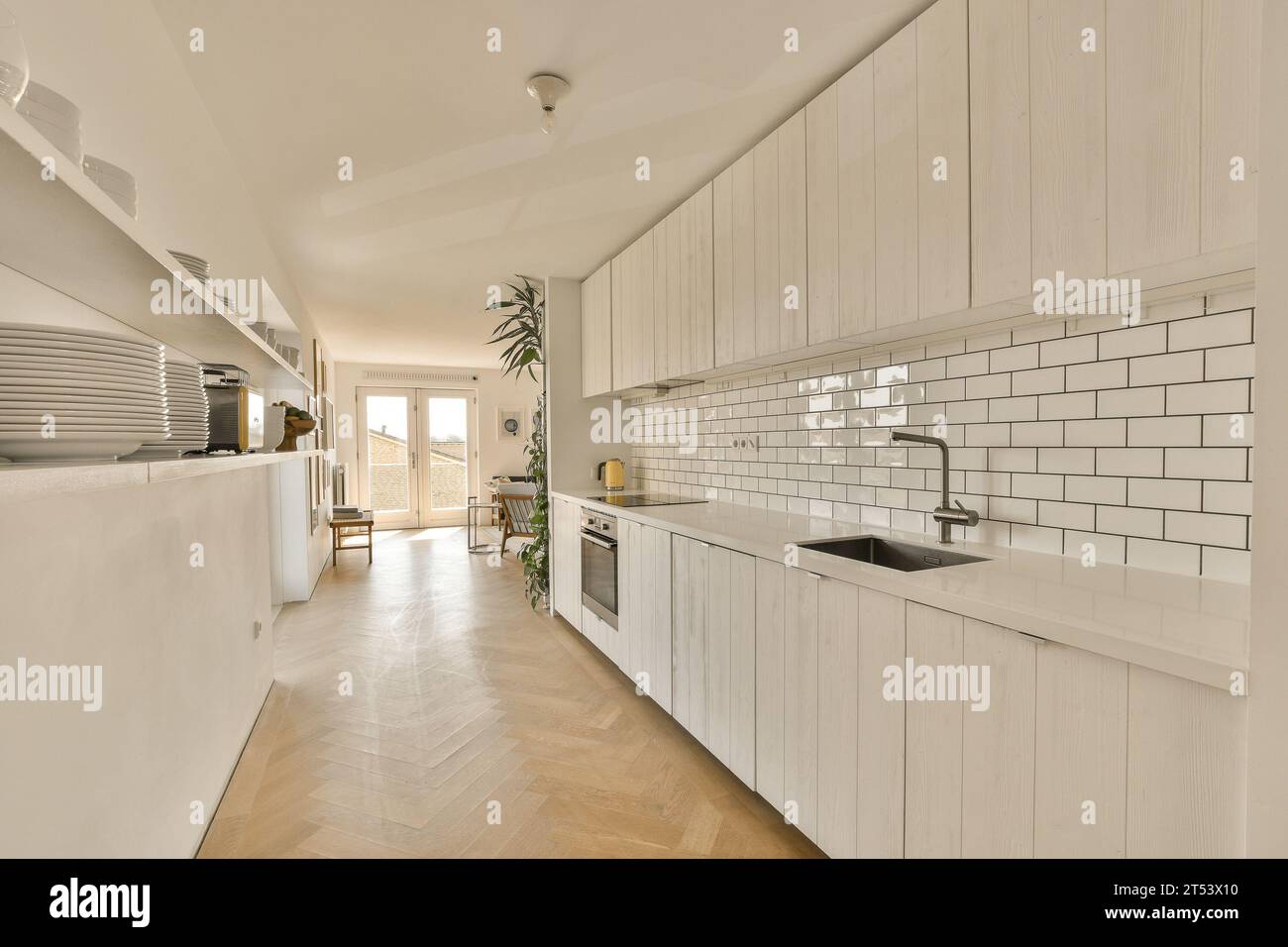 a kitchen with white cabinets and wood flooring in the center of the ...