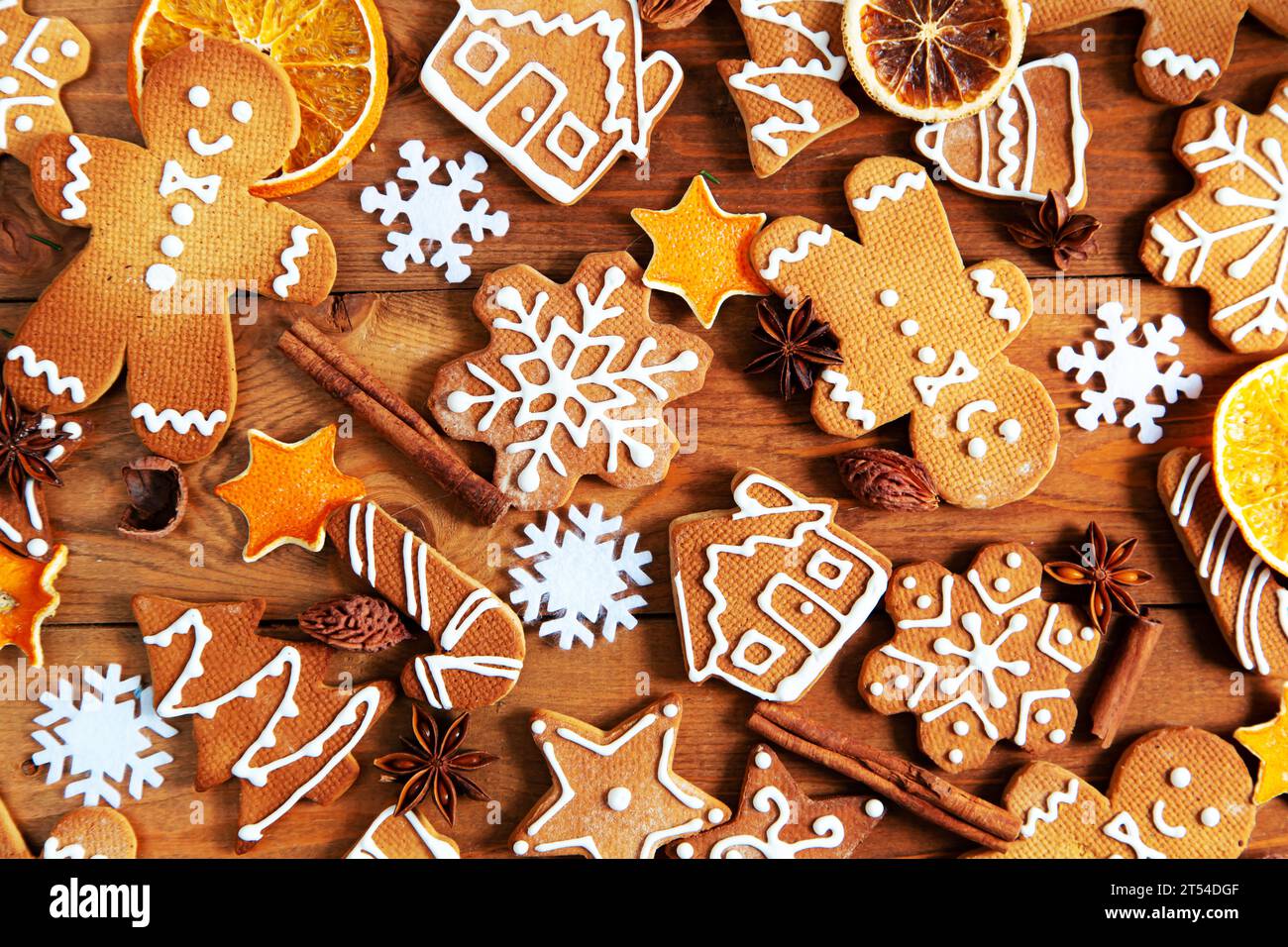 Christmas homemade gingerbread cookies and spices on a wooden background. Stock Photo