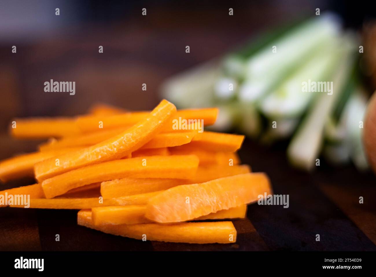 Chopped carrot on wooden board selective focus. Julienne Carrots On The Food Preparation Table. Stock Photo