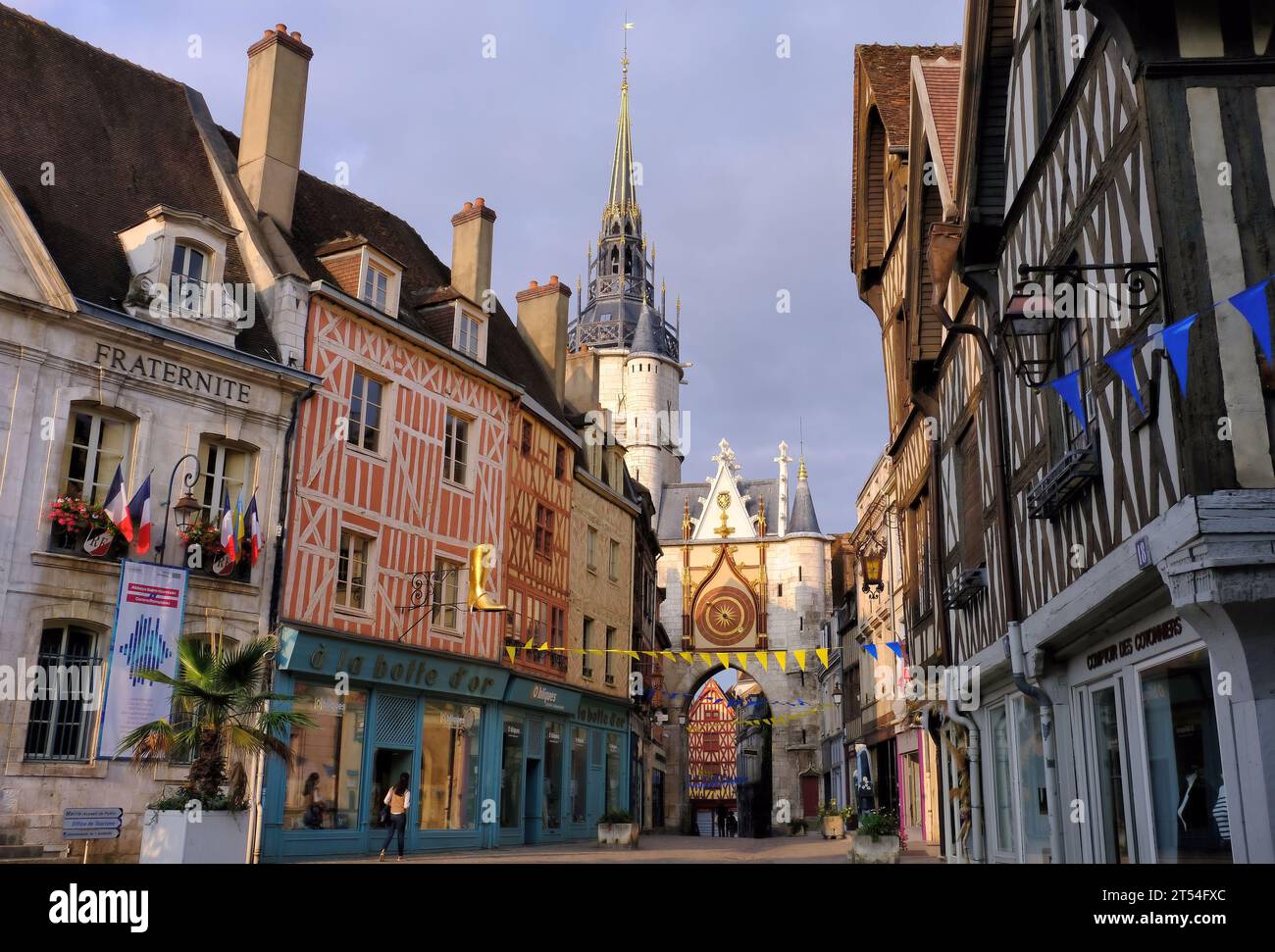 Auxerre: La Tour de l’Horloge (Clock tower) and half timbered buildings in Place de l’Hotel de Ville soon after sunrise in Auxerre, Burgundy, France Stock Photo