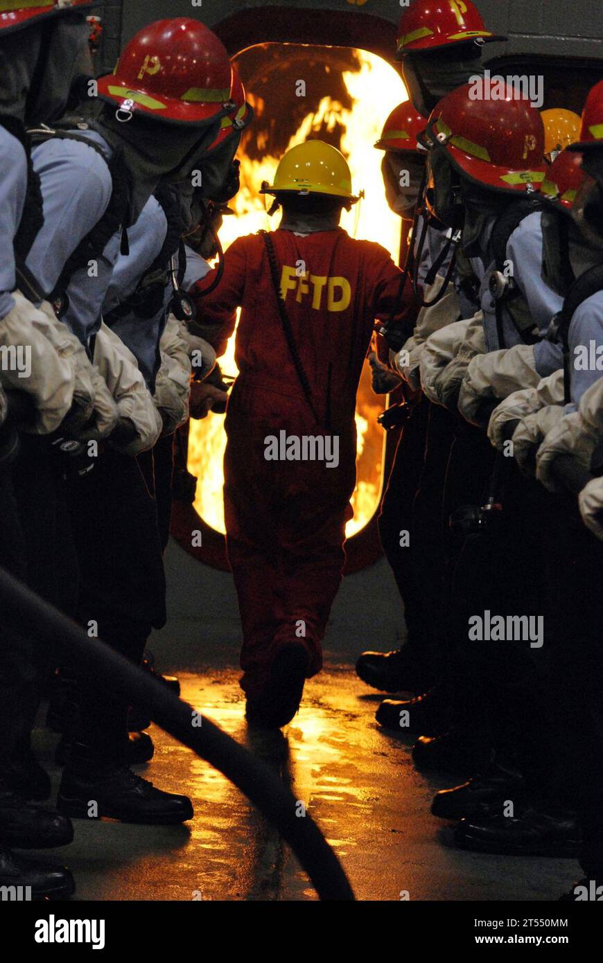 FIRE FIGHTING EXERCISE, hose handling, TRAINING SHIP'S ENGINE ROOM. Stock Photo