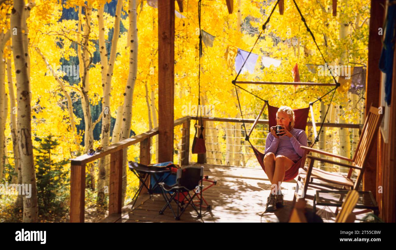 Woman relaxing at a mountain cabin in the fall foliage Stock Photo - Alamy