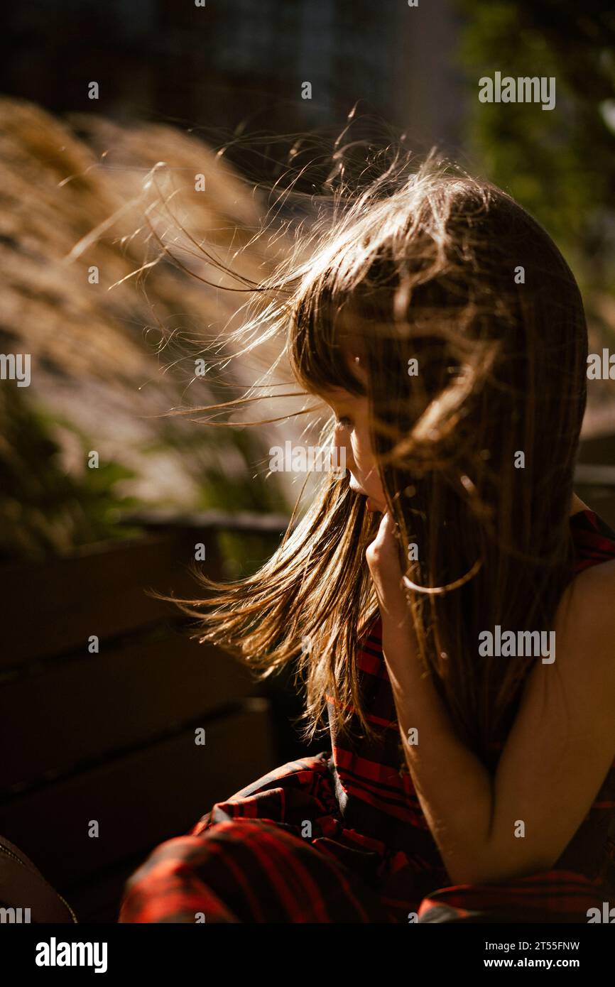 Emotional portrait of a little girl with long brown hair. Stock Photo