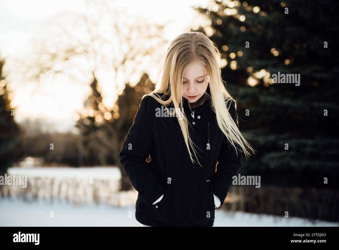 Close up front view of teen girl with long blond hair standing o Stock ...