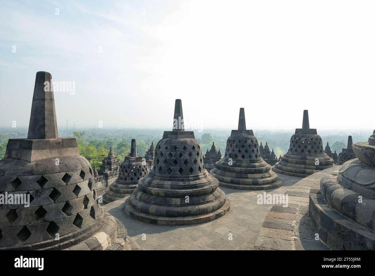 (Selective focus) Stunning view of the Borobudur bell shaped stupas during a beautiful sunrise. Borobudur is a Mahayana Buddhist temple in Indonesia. Stock Photo