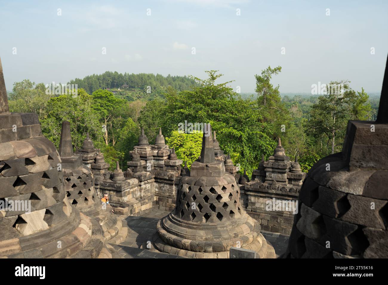 (Selective focus) Stunning view of the Borobudur bell shaped stupas during a beautiful sunrise. Borobudur is a Mahayana Buddhist temple in Indonesia. Stock Photo