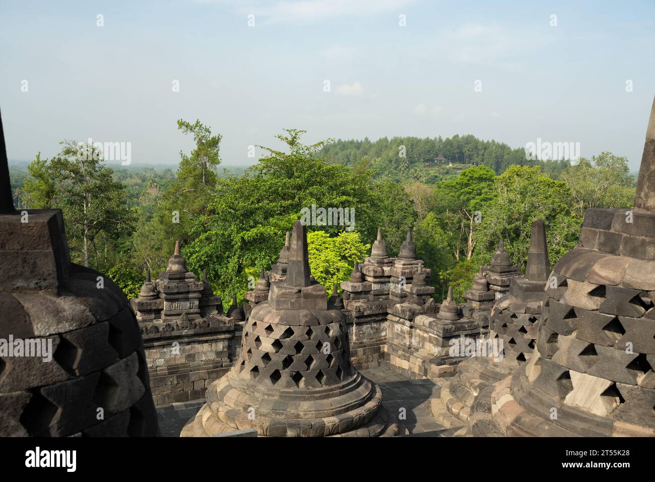 (Selective focus) Stunning view of the Borobudur bell shaped stupas during a beautiful sunrise. Borobudur is a Mahayana Buddhist temple in Indonesia. Stock Photo