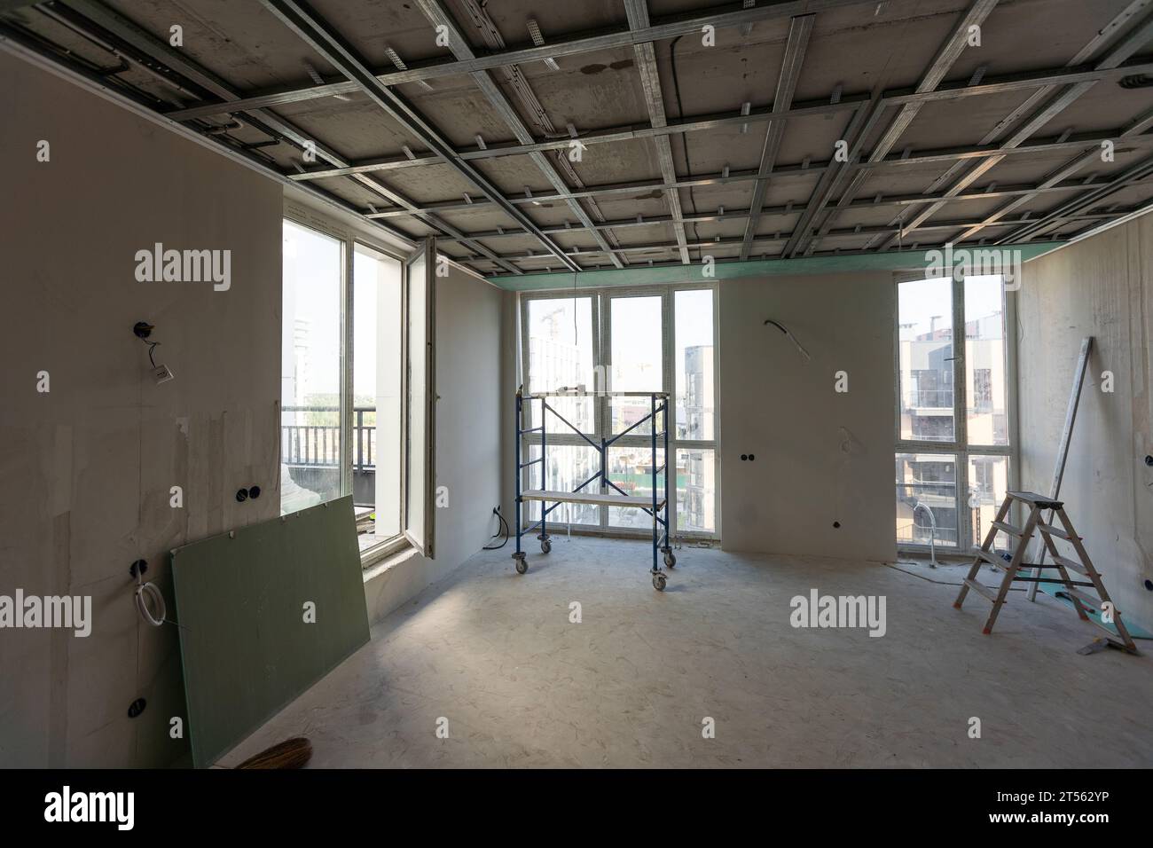 Drywall installation work in progress by construction workers at