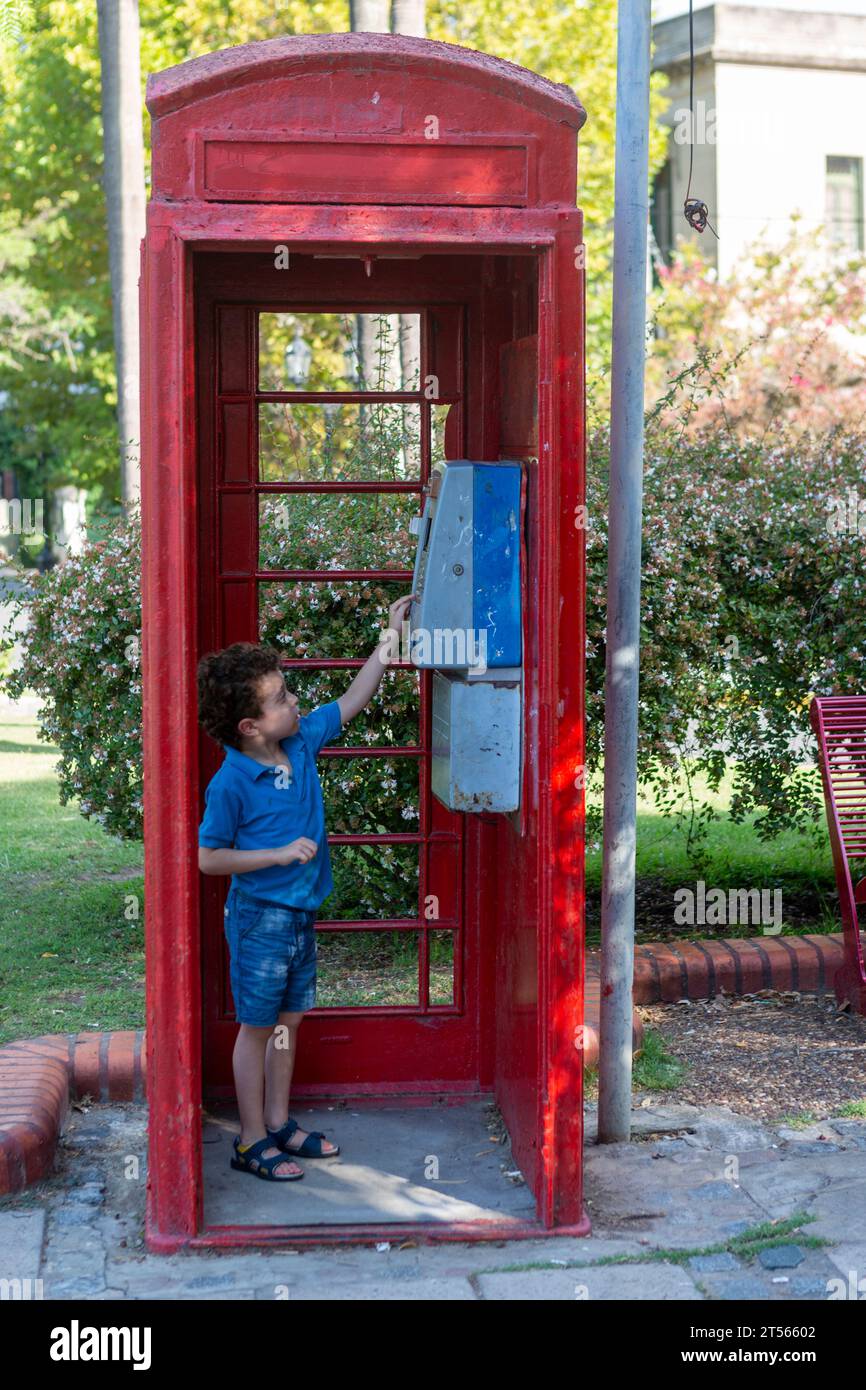 boy inside old telephone booth Stock Photo