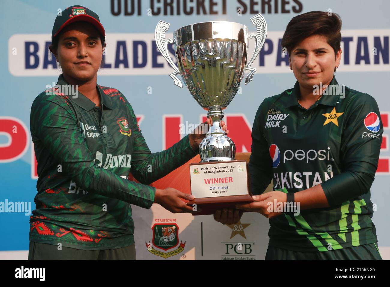 Captains of Bangladesh and Pakistan women cricket team Nigar Sultana Joty (L) and Nida Dar (R) unveil the One Day International (ODI) series Trophy at Stock Photo