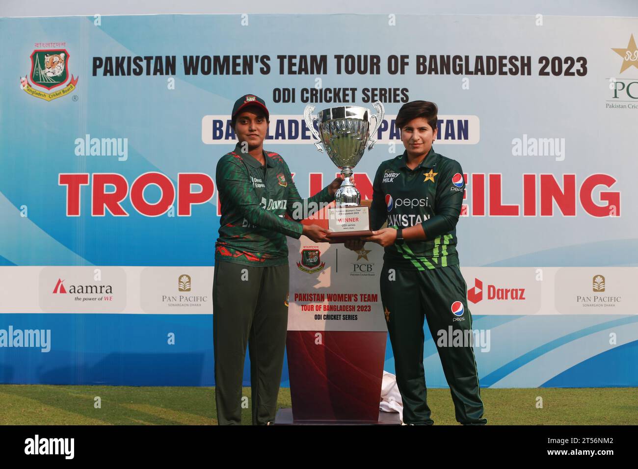 Captains of Bangladesh and Pakistan women cricket team Nigar Sultana Joty (L) and Nida Dar (R) unveil the One Day International (ODI) series Trophy at Stock Photo