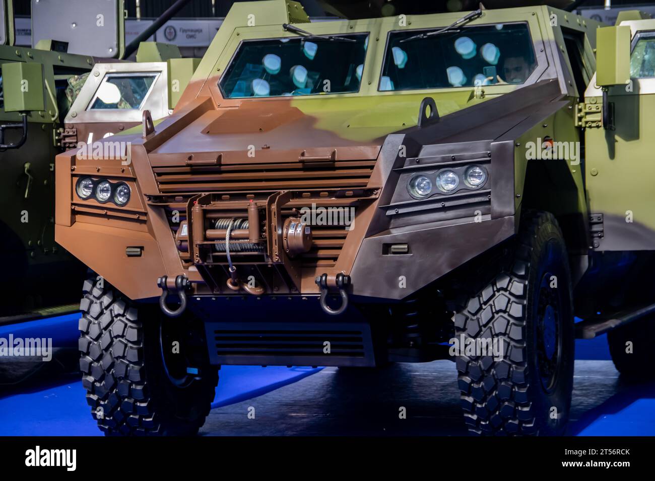 Armored combat vehicle painted in camouflage colors, armed with lethal machine gun and rocket launcher, at the international arms fair in Belgrade Stock Photo
