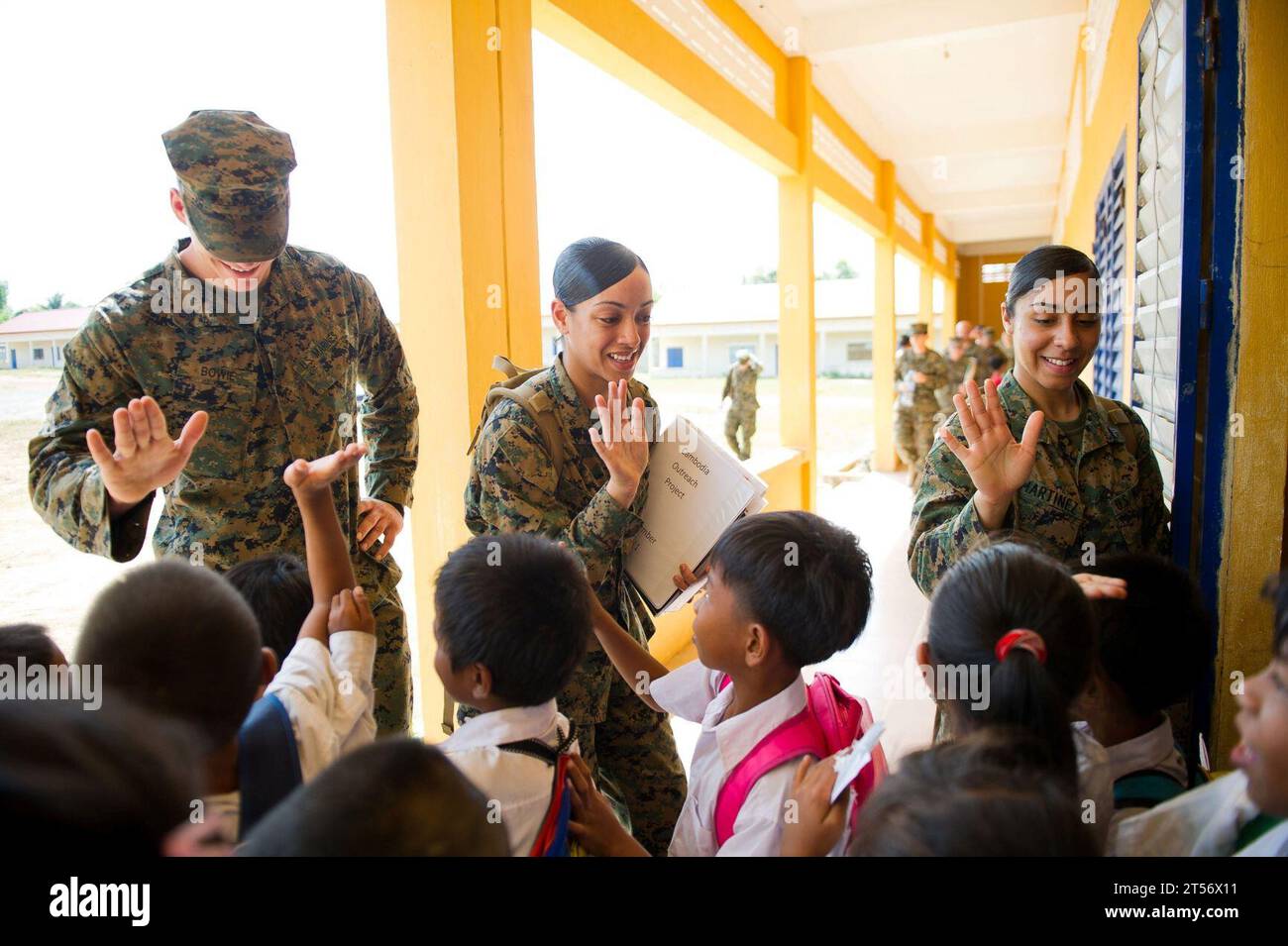 US Navy 111215IS773-019 Marines assigned to the logistics combat element of the 11th Marine Expeditionary Unit high-five Cambodian students leav.jpg Stock Photo