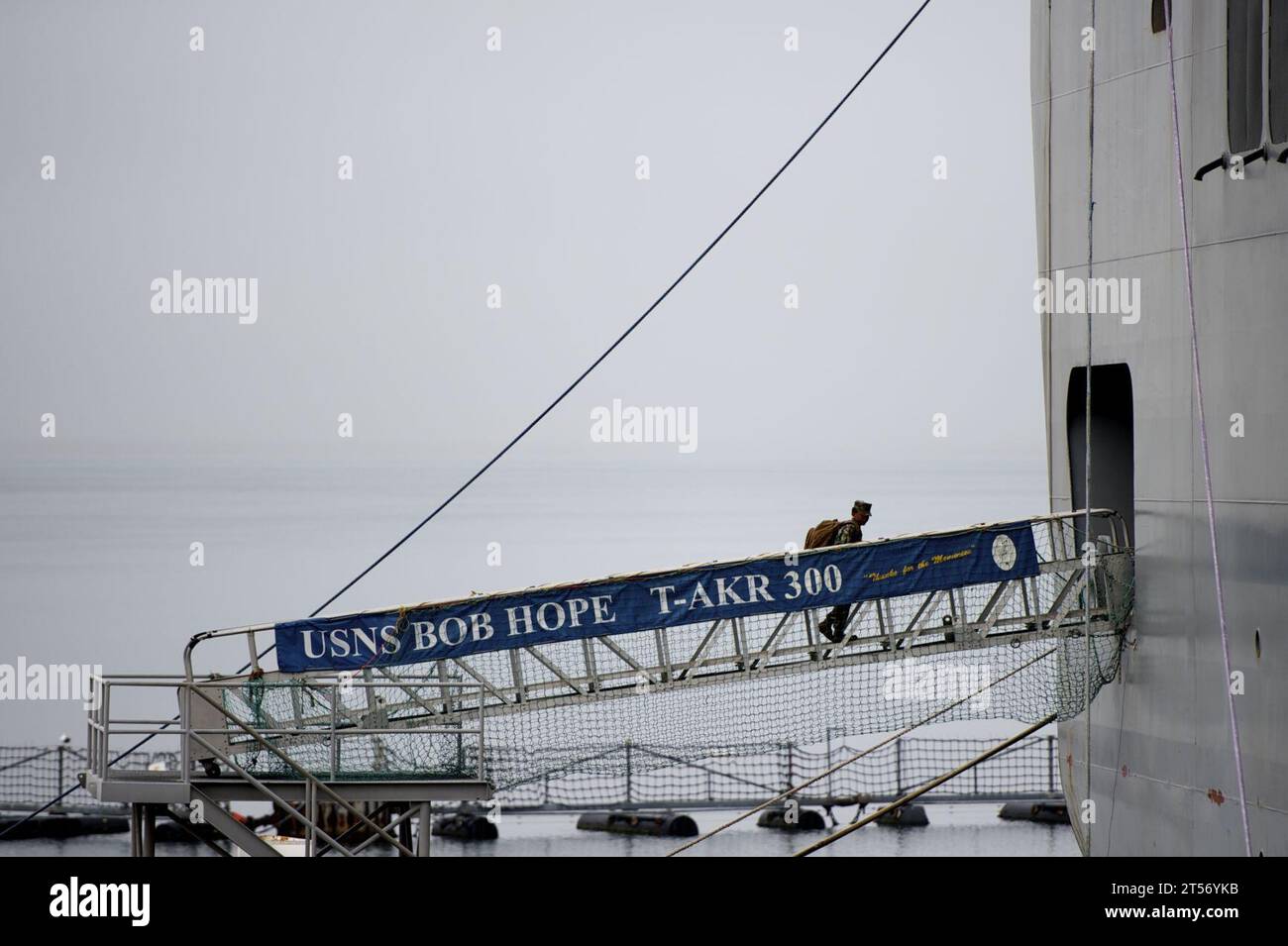 US Navy A Sailor climbs the ramp from the pier to the ship at Naval ...