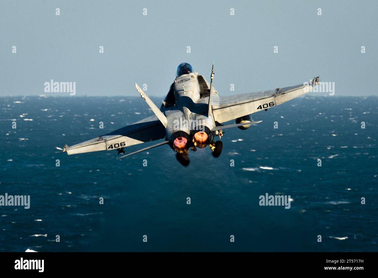 US Navy An F18C Hornet assigned to the Golden Dragons of Strike Fighter Squadron (VFA) 192 launches from the Nimitz-class air.jpg Stock Photo