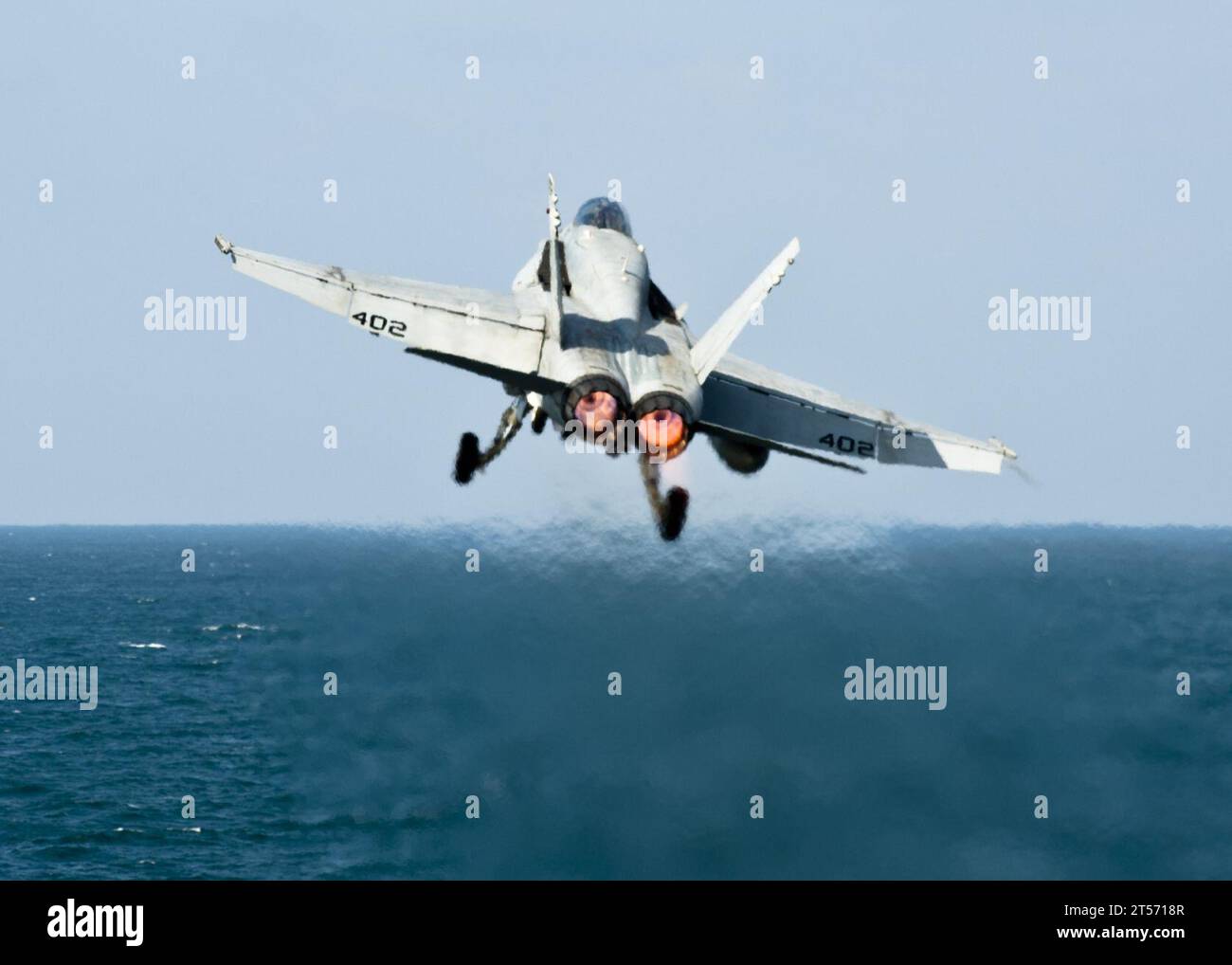US Navy An F18C Hornet from the Golden Dragons of Strike Fighter Squadron (VFA) 192 launches off the Nimitz-class aircraft ca.jpg Stock Photo