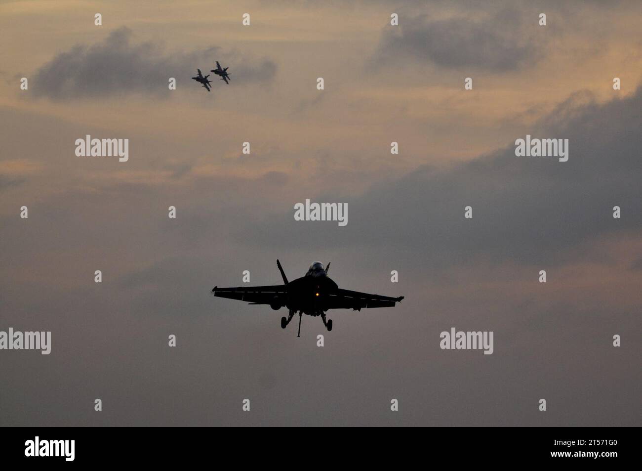 US Navy An F18F Super Hornet, assigned to Strike Fighter Squadron (VFA) 22, approaches to land on the flight deck of the Nimi.jpg Stock Photo