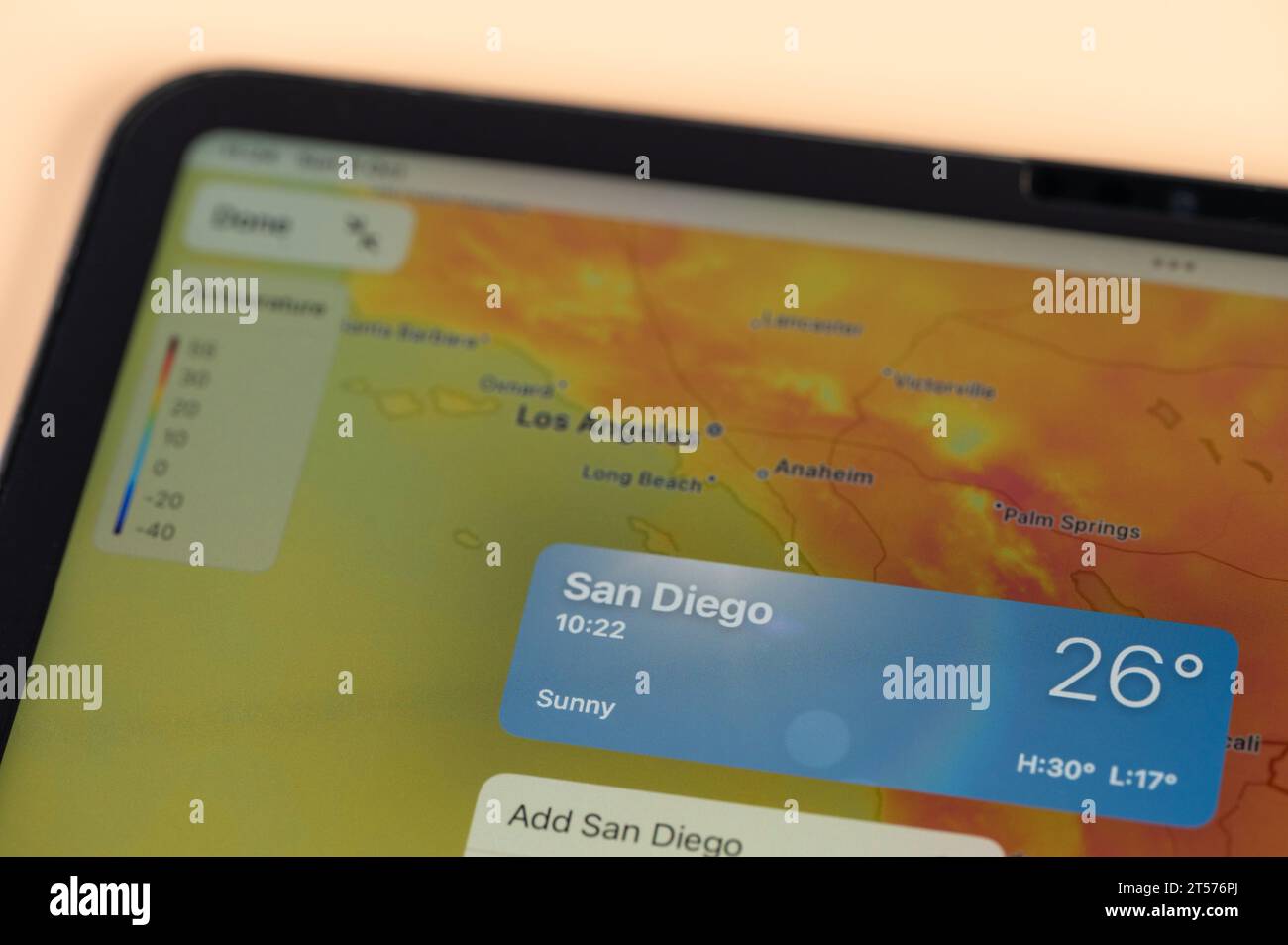 New York, USA - October 8, 2023: Checking temperature outside in San Diego city on online app ipad tablet screen close up view Stock Photo