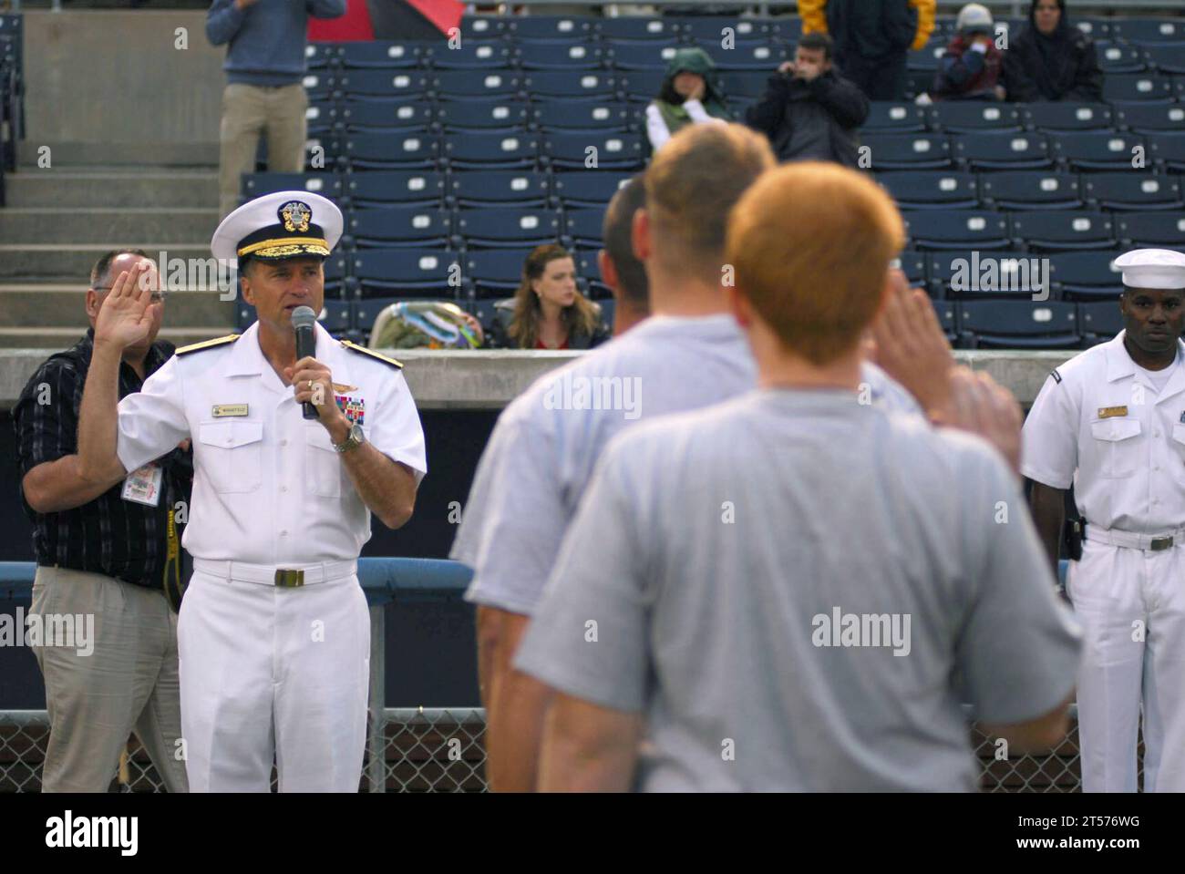 US Navy Rear Adm. James Winnefeld Jr., director of Joint Innovation and Experimentation Directorate, administers the oath of enlistment to future Sailors during Military Appreciation Night at Harbor Park.jpg Stock Photo