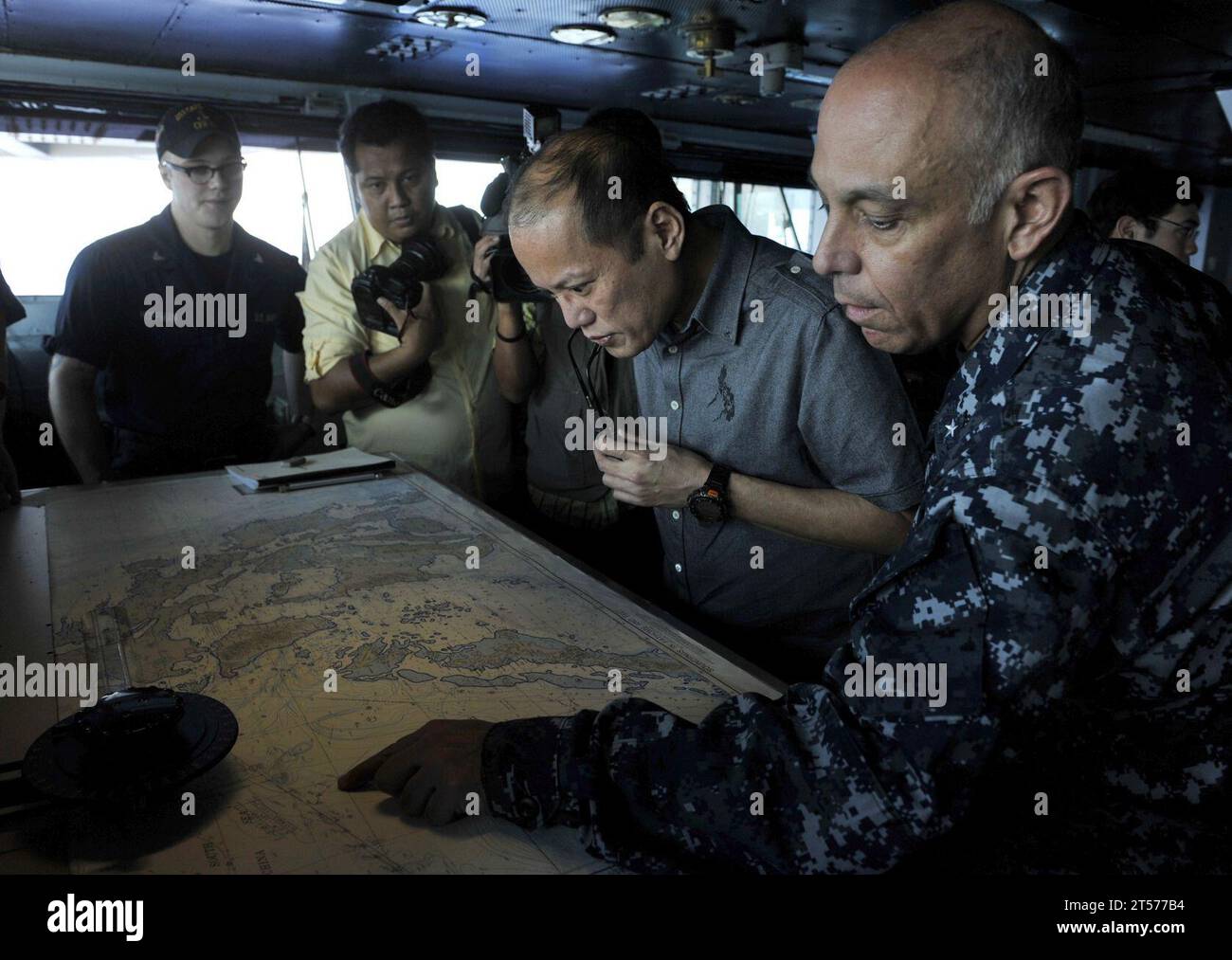 US Navy Republic of the Philippines President Benigno Aquino III studies charts of the Philippines with Rear Adm. Samuel Perez,.jpg Stock Photo