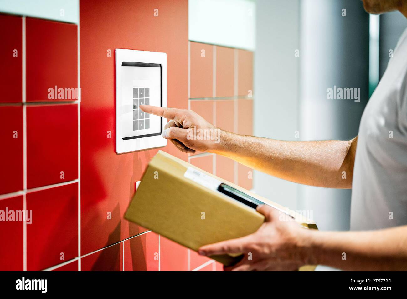 Package locker machine. Parcel service. Box and mobile phone. Man using code to collect delivery. Shipment terminal at post office. Stock Photo