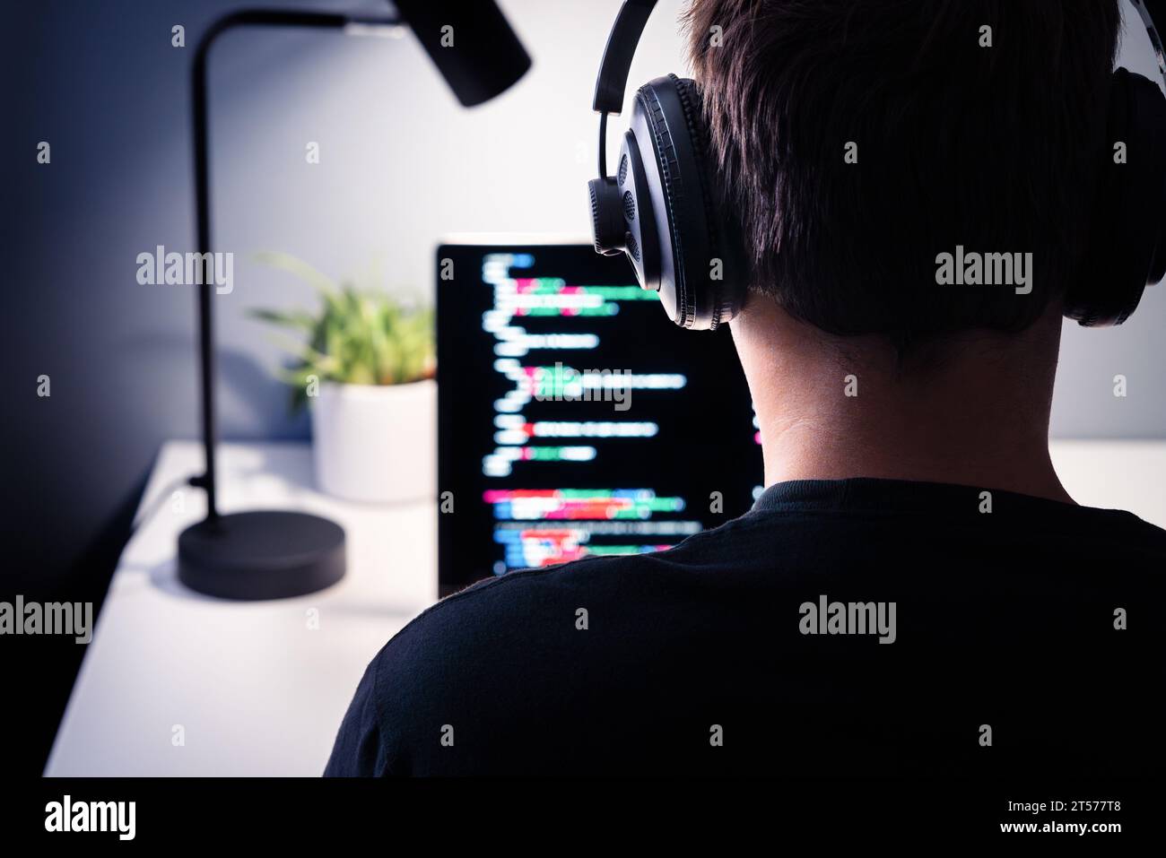 Hacker or code developer with laptop. Malware, game or website developing. Cyber criminal, programmer, engineer or coder. Fraud software or privacy. Stock Photo