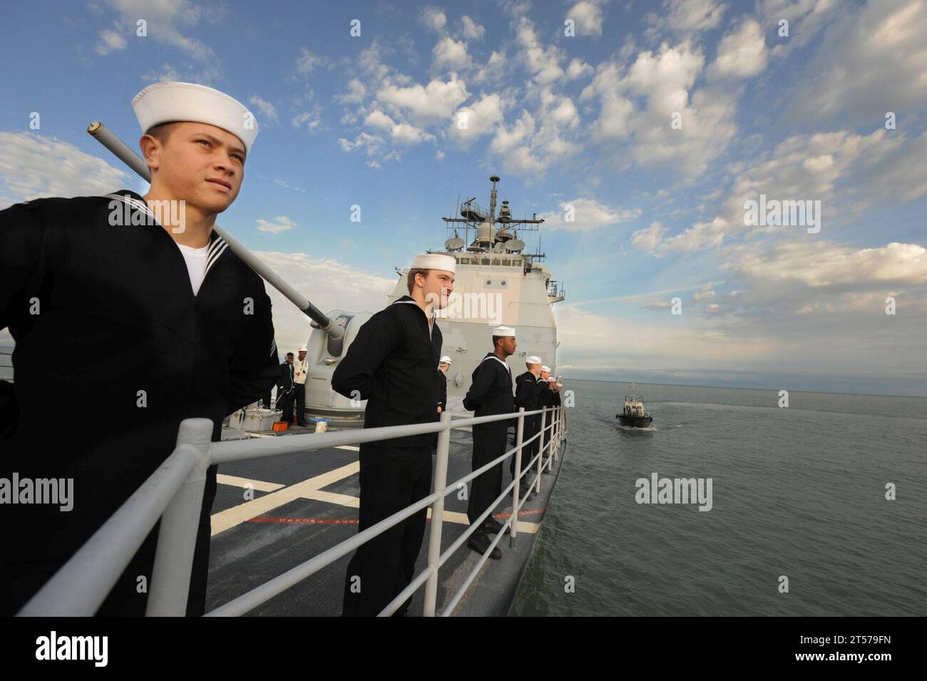 US Navy Sailors man the rails aboard the guided-missile cruiser USS ...