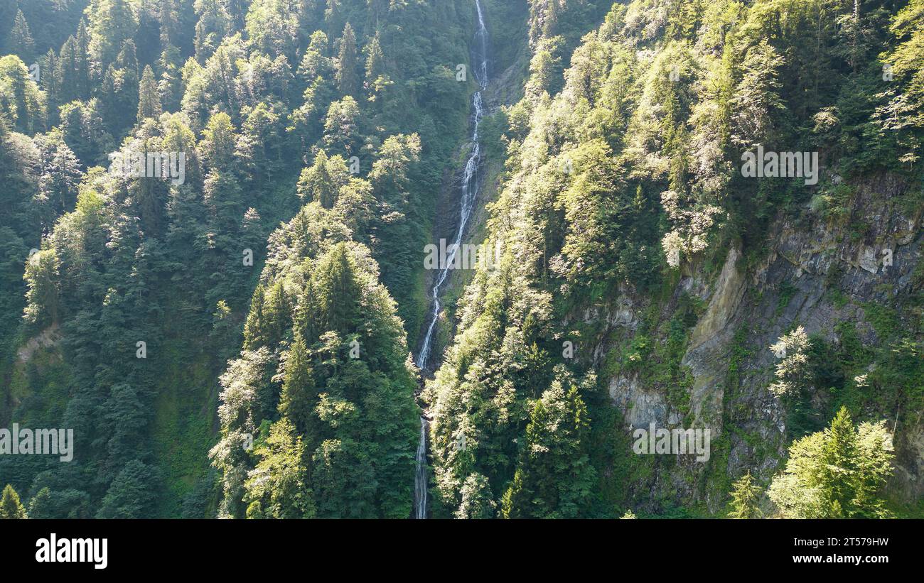 Tar stream cloud waterfall. Aerial view of waterfall flowing over mountain covered with forest. Natural beauties of Rize. Tourist places of Turkey. lo Stock Photo