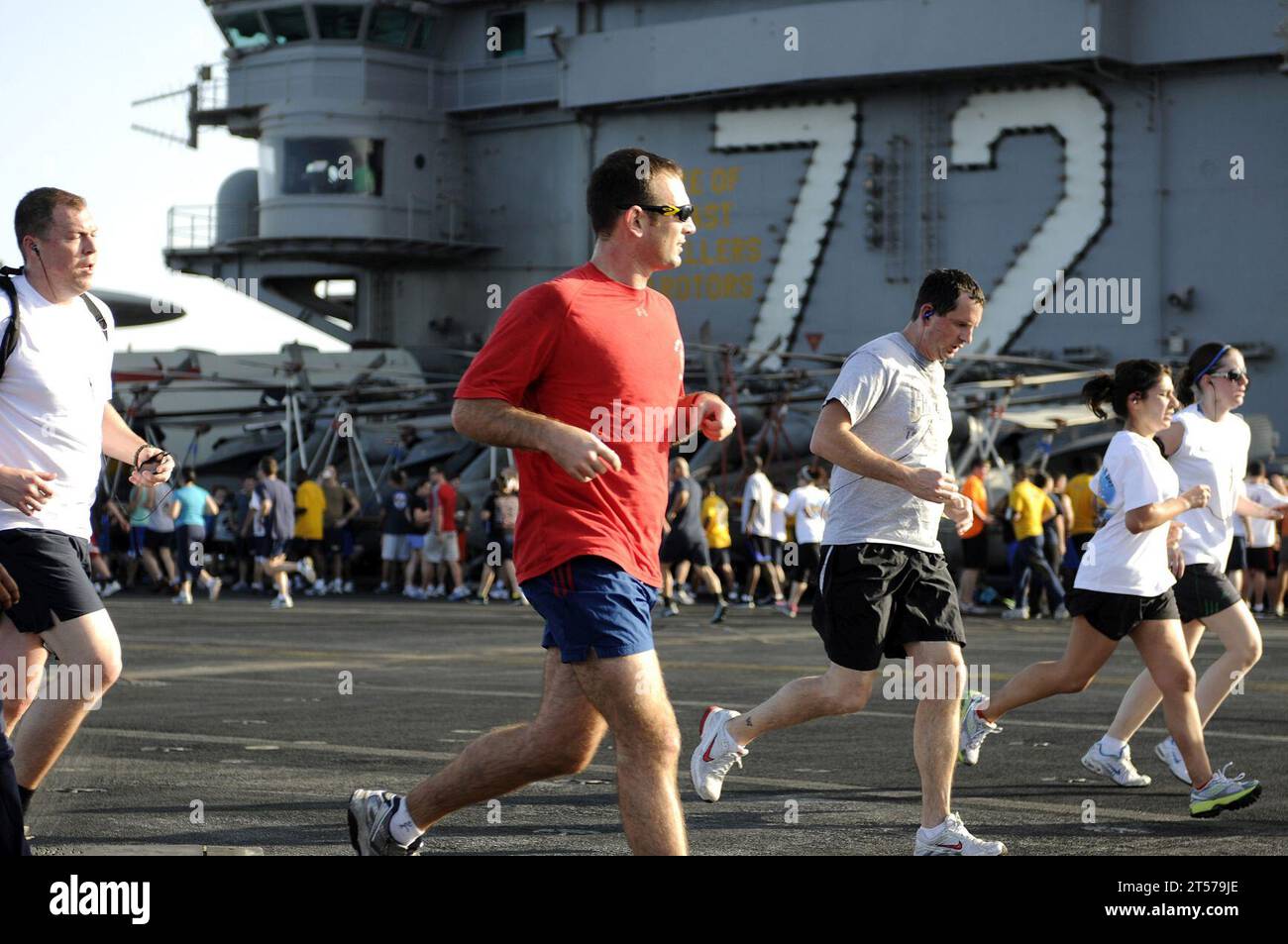 US Navy Sailors participate in a 5-kilometer fun run on the flight deck ...