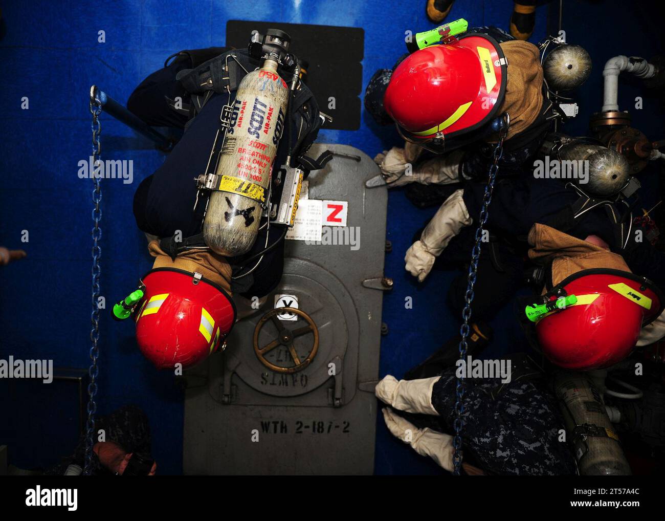US Navy Sailors secure a watertight hatch during a general quarters ...