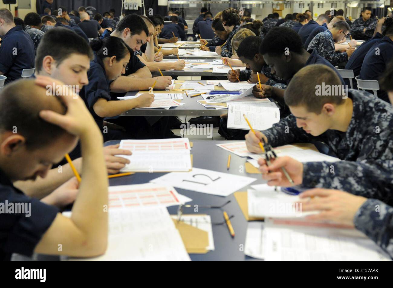 US Navy Sailors take the Navywide E4 advancement exam on the mess