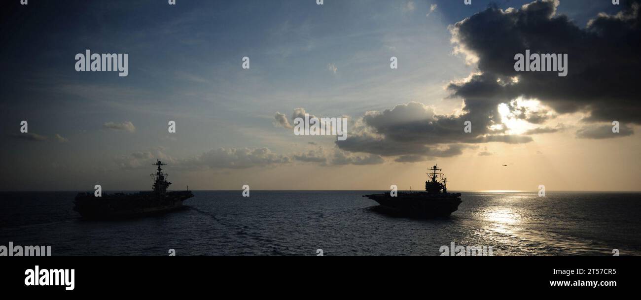 US Navy The Nimitz-class aircraft carriers USS Abraham Lincoln (CVN 72) and USS John C. Stennis (CVN 74) join for a turnover of.jpg Stock Photo