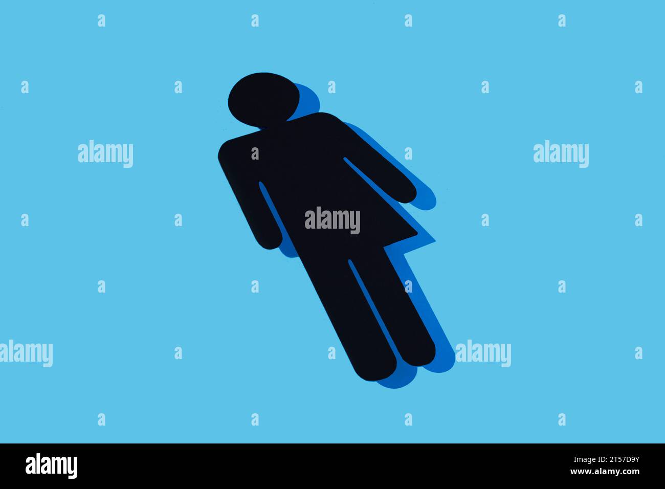 a black gender neutral icon with a dark blue shadow, on a light blue background Stock Photo