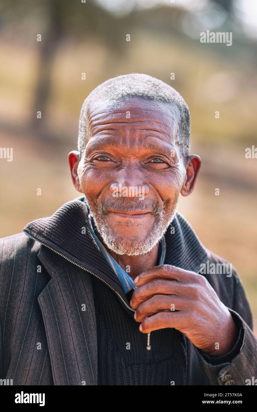 portrait of an unshaved old african man in the village,late afternoon Stock Photo