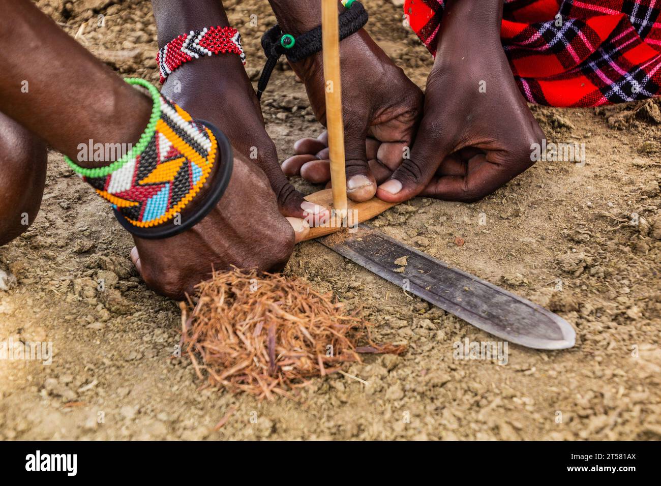 Detail of Masai men making a fire, Kenya Stock Photo