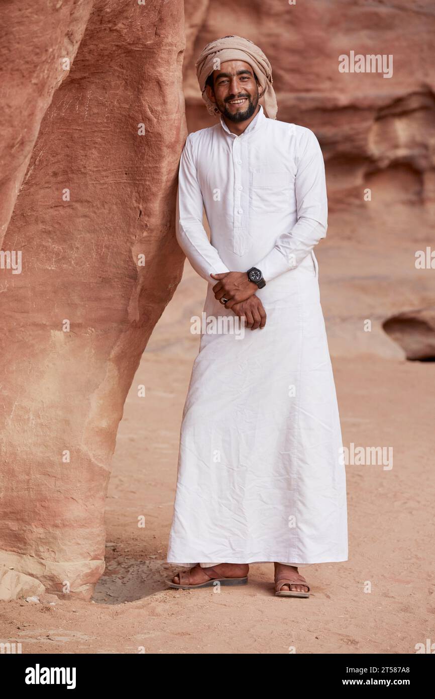Portrait of Bedouin in white Thobe leaning against red rock Wadi Rum Aquaba Jordan Stock Photo Alamy