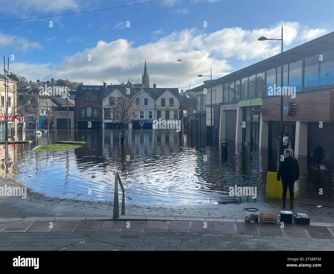 Flooding in the streets of Downpatrick. Business owners and residents in Downpatrick have said the town is left feeling 'hopeless' by flooding that has shown little sign of subsiding. Efforts to remove to manually remove floodwater with pumps have not been able to begin due to persistent high water levels in the River Quoile, which runs beside the town. Downpatrick has been described as being like a bowl, with flood water unable to flow out of the town centre. Picture date: Friday November 3, 2023. Stock Photo