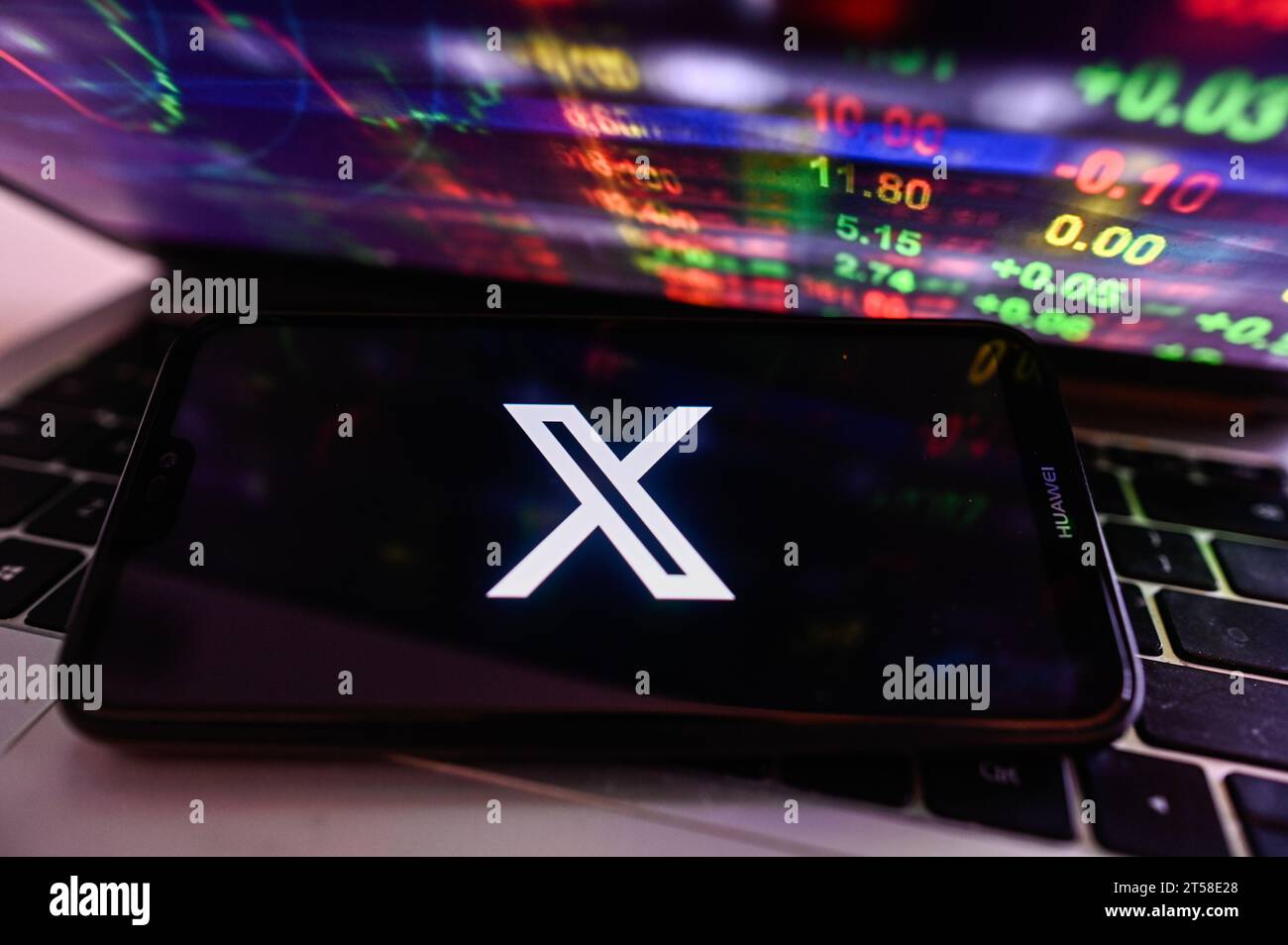 In this photo illustration  a X logo is displayed on a smartphone with stock market percentages on the background. Stock Photo