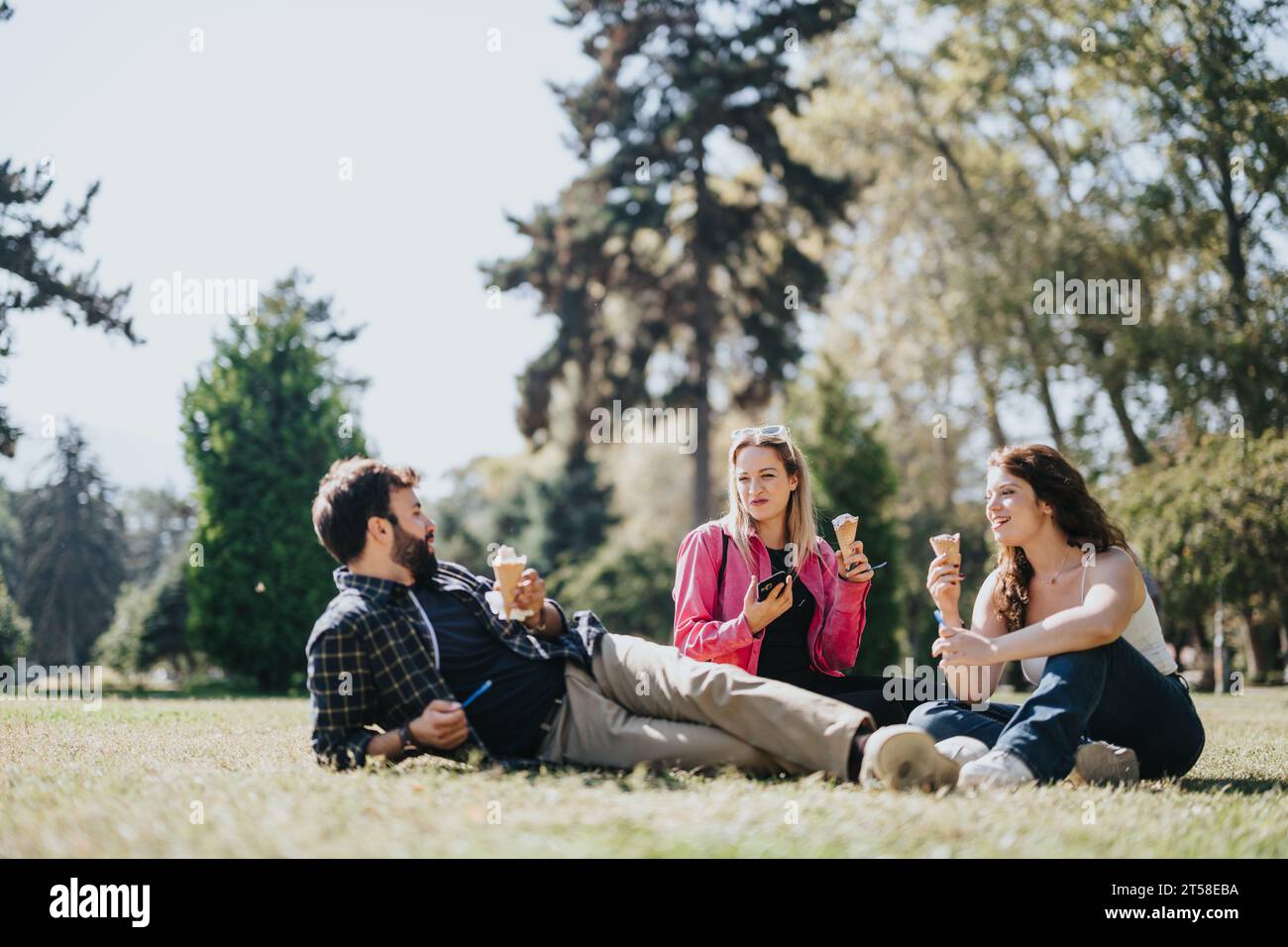 A cheerful group of friends enjoys a sunny day off in a city park ...