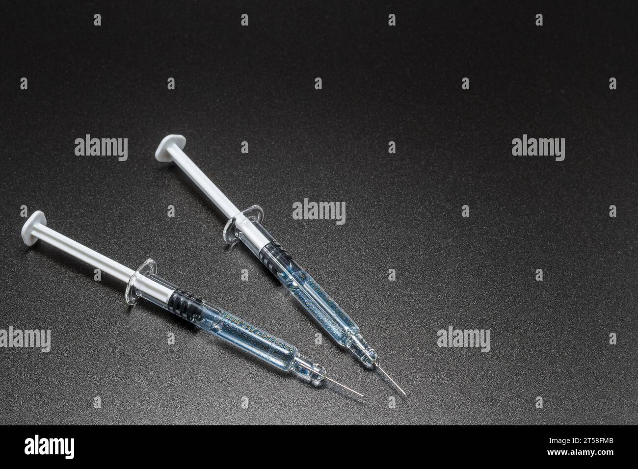 Medical syringes and needles on black background. Medical concept ...