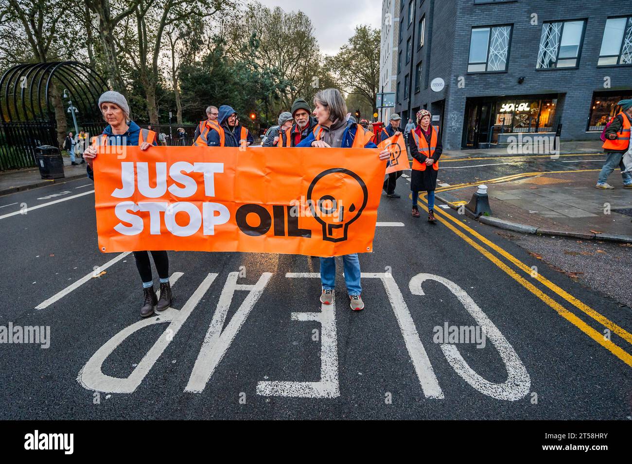 London, UK. 3rd Nov, 2023. The slow walking road block sets off from bethnal green as heavy rain falls - Just Stop Oil continue their climate protest with an action in East London. They demand that, in order to stop climate change, no new licences should be granted for fossil fuel extraction. Credit: Guy Bell/Alamy Live News Stock Photo