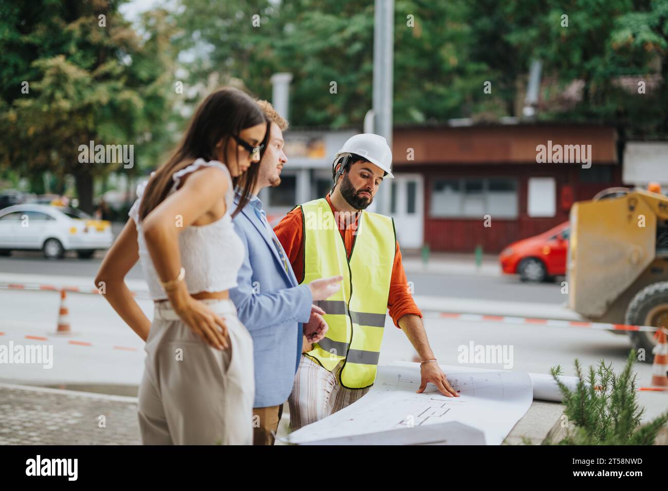 Architectural Team Discussing Project Design Outdoors with Successful Collaboration Stock Photo