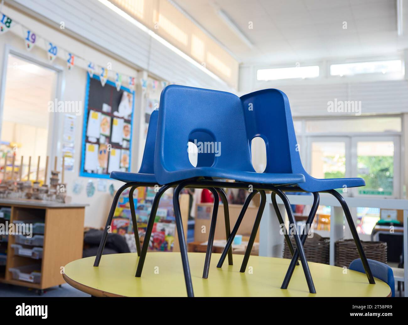 Chairs On Tables In Empty Primary Or Elementary School Classroom At End Of The Day Stock Photo