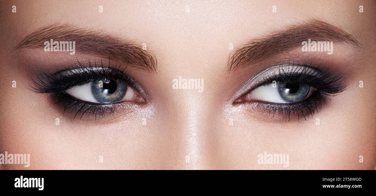 Beautiful female eyes with long eyelashes. Eyelash extensions. Makeup, cosmetics, beauty. Close up, macro Stock Photo
