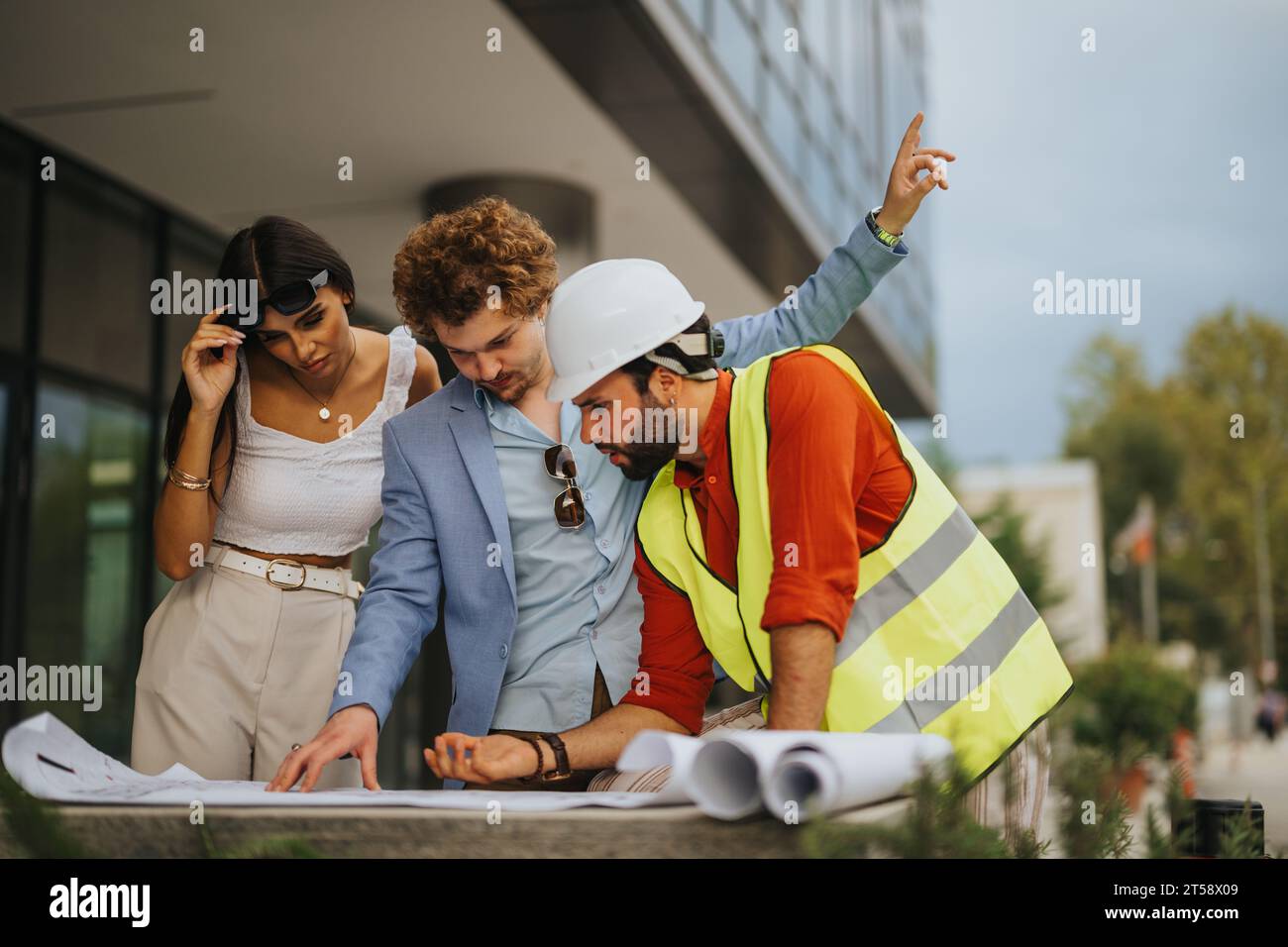Innovative Architects Discussing Blueprint for Construction Project ...