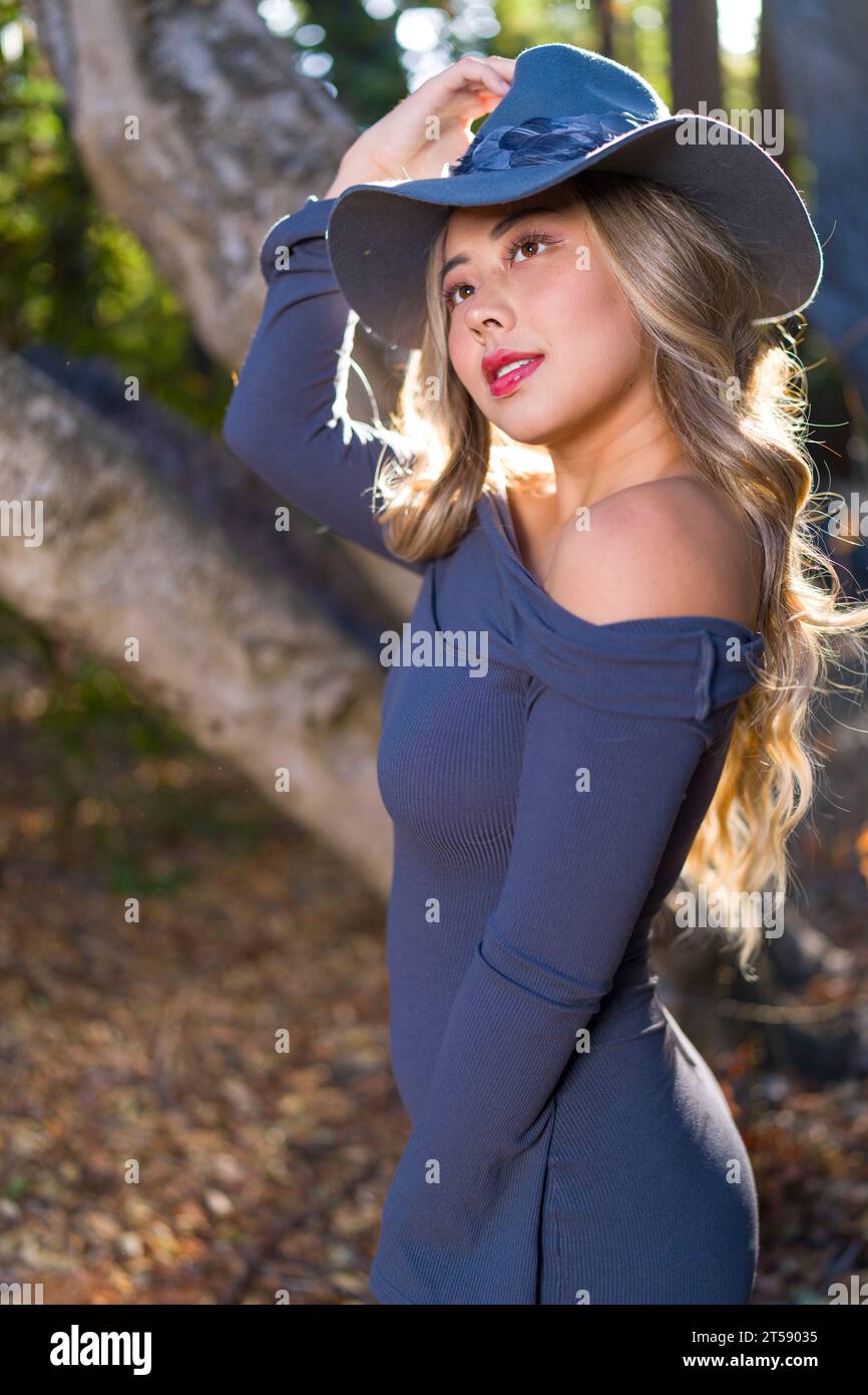 Beauxbatons Witch Enchanting Young Asian Woman Wearing Grey Long Sleeve Dress, Wig, and Hat Stock Photo