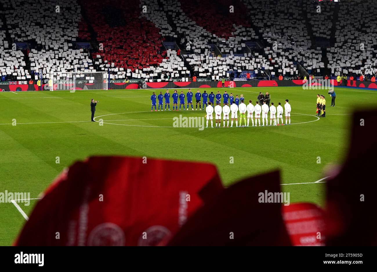 Leicester City and Leeds United players stand during a minute silence